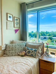 a bed sitting next to a window in a bedroom