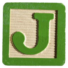 the letter j is made out of wood and has green paint on it's surface