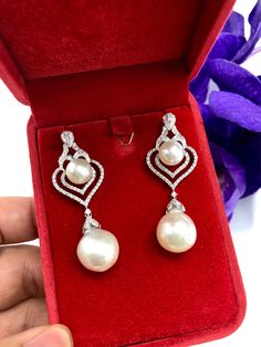 We are presenting you a HUGE pair of CHANDELIER, Genuine, PURE White South Sea Pearls, extremely FINE A+, LUSTROUS and Rare! Accenting the 4 pearls are 136 pieces of E/VS Natural diamonds, weighting a total of 1.62 carats. Set in fabulously designed 18K solid white gold earrings ONLY ONE ITEM AVAILABLE!! NO DUPLICATES!! WHAT YOU SEE IN THE PICTURES IS WHAT YOU WILL GET SOLIDLY HANDCRAFTED EARRINGS! SUGGESTED RETAIL VALUE: $10,880 PEARLS: Size: Bottom Pair 14 x 15 mm, Top Pair 11 mm. Shape: Round Elegant White Drop Pearl Earrings, Luxury White Gold Teardrop Pearl Earrings, Luxury White Gold Drop Pearl Earrings, White Diamond Teardrop Pearl Earrings, Exquisite White Teardrop Pearl Earrings, White Teardrop Diamond Pearl Earrings, White Drop Jewelry With Elegant Design, Luxury White Diamond Bridal Earrings, White Drop Pearl Earrings For Anniversary