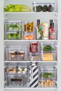 an open refrigerator filled with lots of food and condiments in containers on the shelves