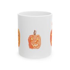 a white coffee mug with an orange pumpkin on it