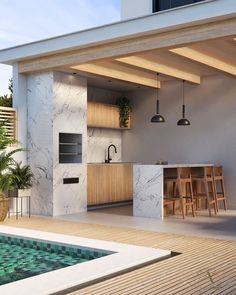 an outdoor kitchen next to a swimming pool