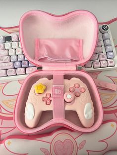 a pink controller case sitting next to a keyboard