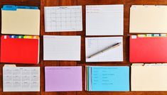 several different types of notepads on a wooden table