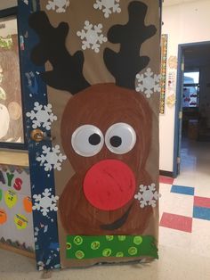 a door decorated to look like a reindeer with snowflakes on its nose and nose