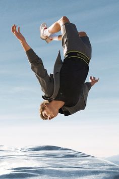 a man flying through the air while riding a skateboard