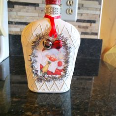 a bottle with a christmas decoration on it