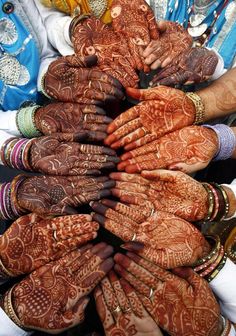 many people are holding their hands together to show off their hendigns and jewelry