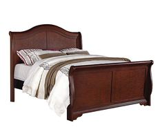 a bed that has a wooden frame and headboard with pillows on top of it