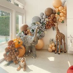 a giraffe and some balloons in a room