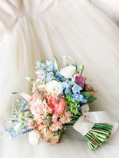 a bridal bouquet on the back of a wedding dress