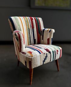 a colorful striped chair sitting on top of a floor