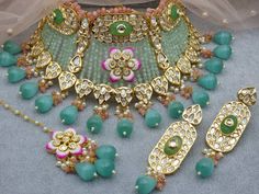 Elegant Green Gold Kundan Bridal Jewelry set to wear with your beautiful outfit on your Special Day. This Jewelry Set Includes a Necklace, Earrings, and Tika. All our Jewelry pieces are delicately hand-made by artisan and can be different from pictures in color and details. This item is delicately handcrafted by artisan and can differ from images in colors and details. We try to take photos as naturally as we can but color can be slight variations due to lighting. Jewelry Care -- Keep all the je Pink Bridal Jewellery, Kundan Choker Set, Bridal Jewellery Set, Kundan Choker, Maang Tikka, Pakistani Jewelry, Onyx Jewelry, Pink Bridal, Color Beads