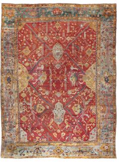 an antique rug with red and blue colors