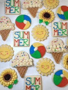 decorated cookies are arranged in the shape of sunflowers, ice cream and beach balls