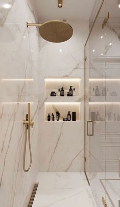 a bathroom with white marble walls and flooring, shower head, shelves on the wall