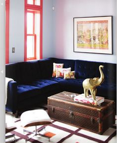 a living room filled with furniture and a painting on the wall