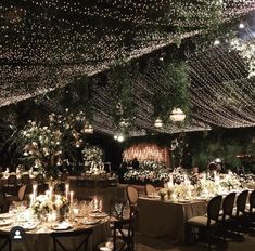 the tables are set with candles, flowers and greenery for an elegant wedding reception