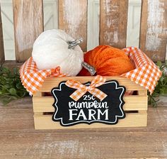 an orange and white pumpkin in a wooden crate with a sign that says pumpkin farm