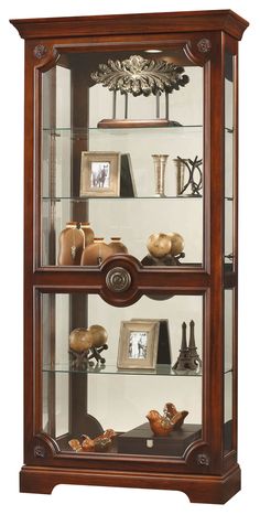 a wooden display case with glass doors and shelves filled with pictures, vases and other items