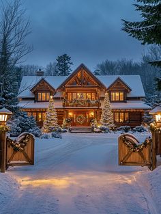 a large house covered in snow with christmas lights on it's front door and driveway