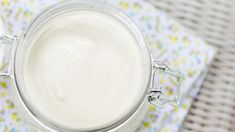 a glass jar filled with milk sitting on top of a table