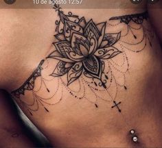 a woman's stomach with a flower tattoo on the side and an arrow in the middle