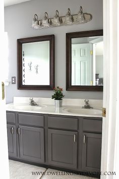 a bathroom with double sinks and two mirrors