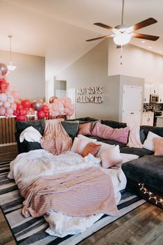 a living room filled with furniture and balloons