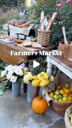 an outdoor market with flowers, fruit and bread