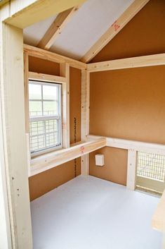 an empty room with shelves and windows in the wall, next to a window sill