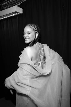 a black and white photo of a woman in a dress