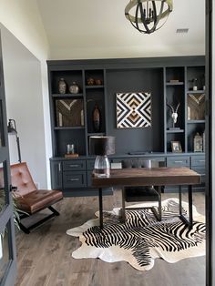 a living room filled with furniture and a zebra rug