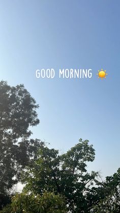 the words good morning are in front of trees and blue sky with sun above them