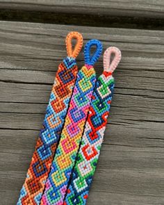 a pair of scissors sitting on top of a piece of beaded fabric next to each other