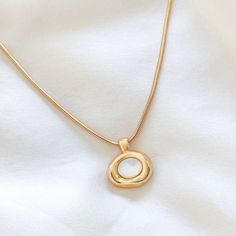 Elevate your everyday look with this gold-filled Molten Bezel Necklace, featuring a lustrous shell pearl at its center. The unique molten bezel design adds a modern, organic touch that makes this necklace stand out. Perfect for layering with other necklaces or wearing on its own for a minimalist statement. 14k Gold Filled Chain 24k Gold Filled Molten Bezel Charm: 21mm x 19mm Chain length: 16", 18", 20" Lobster clasp closure for secure wear Hypoallergenic, perfect for sensitive skin Water resista Necklace Shell, Bezel Necklace, Necklace Stand, Modern Organic, Chain Lengths, Chain Length, Everyday Look, Lobster Clasp, Sensitive Skin