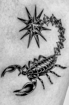 a black and white photo of a scorpion tattoo