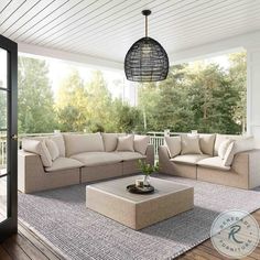 an outdoor living room with couches and coffee table