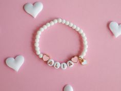 Kids Bracelet with Heart Charms and Natural White Stone Beads Adorn your child's wrist with our beautiful Kids Bracelet, featuring delicate colourful heart charms and natural white stone beads. This lovely accessory adds a touch of elegance and charm to any outfit, making it perfect for everyday wear or special occasions. Key Features: Heart Charms: Cute heart charms that symbolize love and friendship. Natural White Stone Beads: Elegant and durable, these beads add a touch of sophistication. The Cute Heart Bracelet With Round Beads For Valentine's Day, Valentine's Day Playful Beaded Jewelry, Cute Heart Beads Charm Bracelet For Valentine's Day, Personalized Charm Bracelet With Round Beads For Valentine's Day, Playful Round Beads Jewelry For Valentine's Day, Personalized Charm Bracelet For Valentine's Day, Heart-shaped Beaded Bracelets With Charms For Gift, Valentine's Day Personalized Charm Bracelet With Round Beads, Heart-shaped Beaded Bracelets With Charms As Gifts