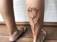 a woman's leg with a flower tattoo on it