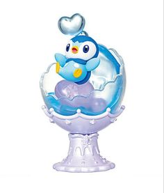 an inflatable penguin floating on top of a bowl with a heart above it