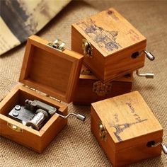 four wooden boxes with metal latches on the lids and handles, one opened to reveal an antique camera