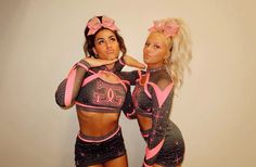 two women in matching outfits posing for the camera