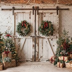 christmas wreaths and presents in front of two wooden doors