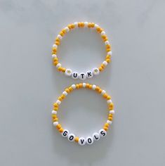 Show your school pride and complete your game day outfit with a custom orange and white beaded bracelet for the University of Tennessee! Personalized White Stretch Bracelet Casual Style, Casual Personalized White Stretch Bracelet, Casual Customized White Wristband, Casual White Personalized Stretch Bracelet, Casual White Wristband With Round Beads, Casual White Beaded Name Bracelet, Casual White Round Bead Wristband, Casual White Round Beads Wristband, School Spirit Beaded Bracelets With Letter Beads For Gifts