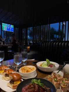 a table filled with plates and bowls of food