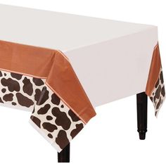 a giraffe print tablecloth with an orange border around the edge and black legs