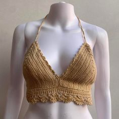 Simple and casual crochet crop top. Repeating flower detailed hemming with swirl neck line. Soft string closures. Perfect summer top and looks great with a pair of shorts. One size Feel free to message us with any questions. Beige Cotton Crochet Top For Festival, Cotton Crochet Lace Top For Beach Season, Beach Crochet Trim Crop Top, Beige Cotton Halter Top For Beach, Triangle Top With Crochet Trim For Beach Season, Cotton Crochet Crop Top For Beach Season, Fitted Cotton Crochet Top For Beach Season, Crochet Trim Triangle Top For Beach Season, Beige Beachwear Tops For Festival