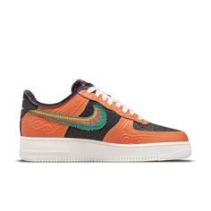 Nike's Air Force 1 SiEMPRE Familia sneakers are a must-have for anyone who loves unique and stylish shoes. Part of the 2021 Día de Muertos collection, these sneakers are inspired by Mictlán, the underworld of Aztec mythology. The toe box and quarter panel feature a pebbled texture in a glossy black finish, contrasted by orange leather overlays embossed with Aztec-inspired designs. A green suede Swoosh, accented with red and yellow embroidery, nods to colorful pigments used in traditional Mexican art. Charcoal-hued velvet lines the interior, while the insole features a Siempre Familia graphic. Traditional Mexican Art, Aztec Mythology, Yellow Embroidery, Art Charcoal, Air Force One, Día De Muertos, Nike Air Force 1 07, The Underworld, Traditional Mexican