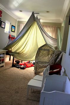 a room with a bed and other items in it that are sitting on the floor